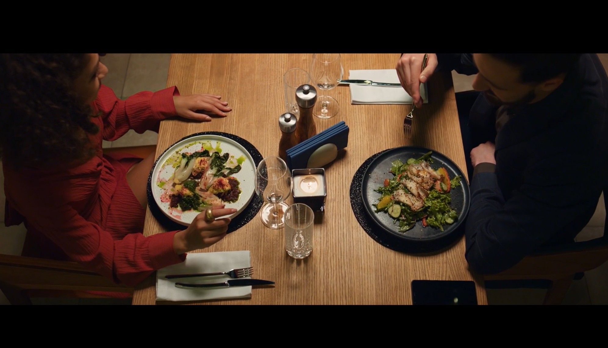 A woman and man dine across from each other at a country-club table